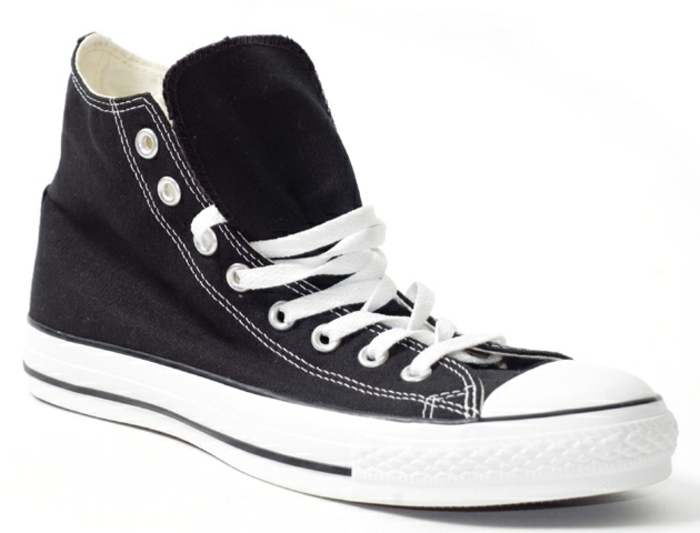 black converse-type sneaker close up, white laces and white rubber soles, plain white background