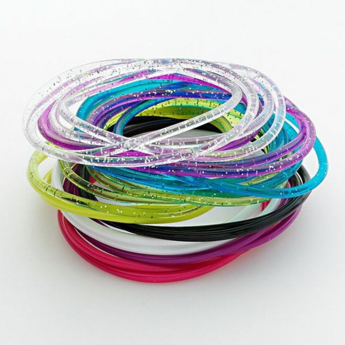 thin plastic sparkling gel bracelets, neon pink blue and green, white black purple and clear, white background