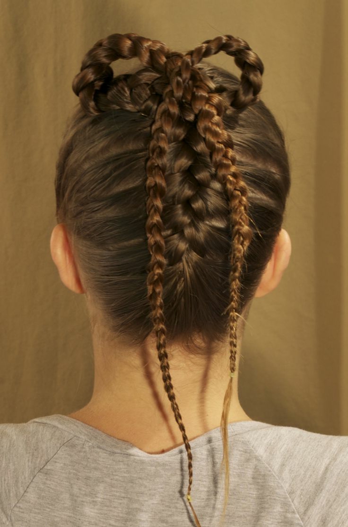 brown braided hair, inspired by medieval times, with two tight braids, forming a bow detail at the top of the head