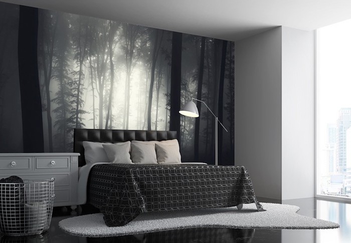 misty forest photo wallpaper, in black and white, inside a room decorated in different shades of gray, bed and lamp, cupboard and clothes basket, bedroom wall decor