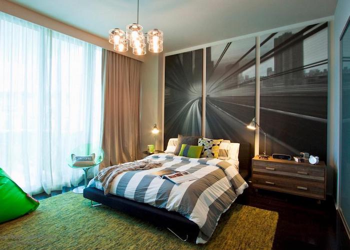 blown up black and white photograph, on three large canvases, large wall art, near double bed, with striped covers and several cushions