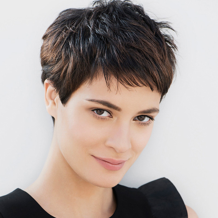 boyish-style dark brunette, extremely short and shaggy pixie cut, with cropped bangs, short haircuts for thin hair, worn by young smiling woman