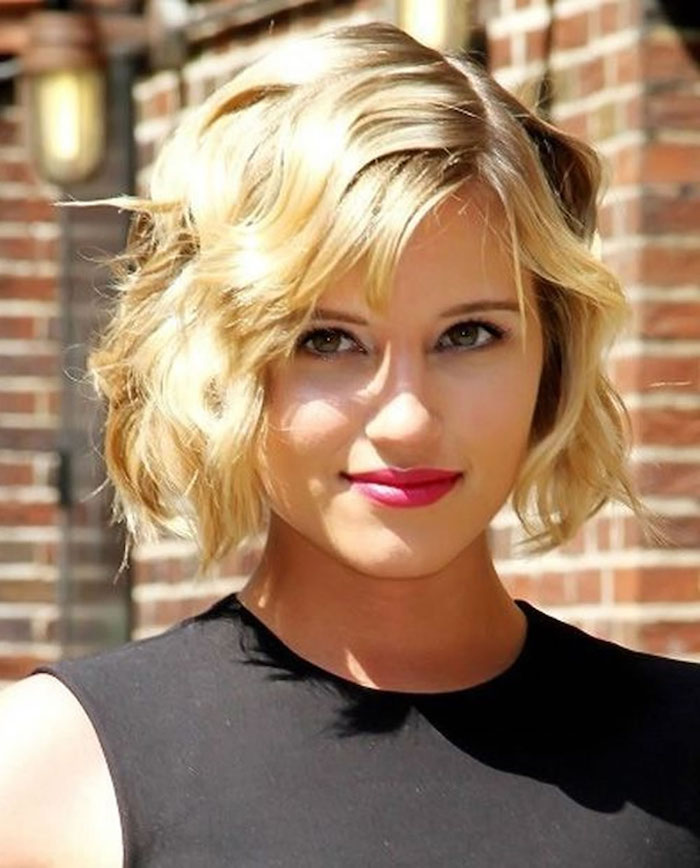 minimalistic black sleeveless top, worn by smiling diana argon, with hot pink lipstick, and vintage-inspired wavy bob, with side part