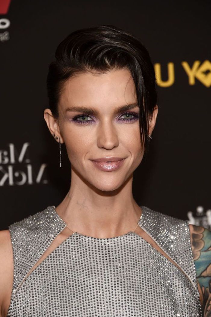 glittering silver sleeveless top, with cutout details, worn by ruby rose, dark eye make up, hairstyles for fine thin hair, wet-look pixie cut, swept over to one side