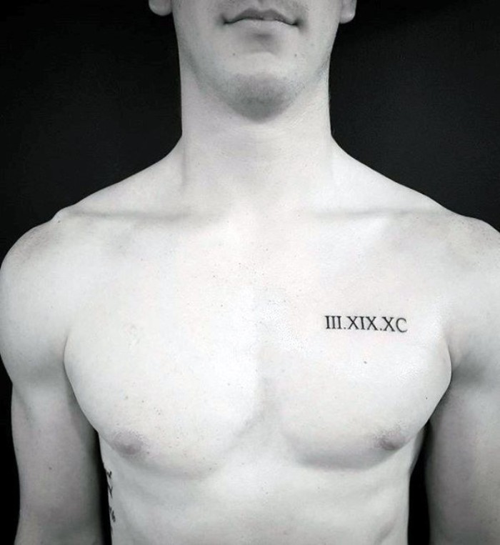 roman numerals tattooed in black, on the left hand side, of a slim and athletic man's chest, meaningful tattoo ideas