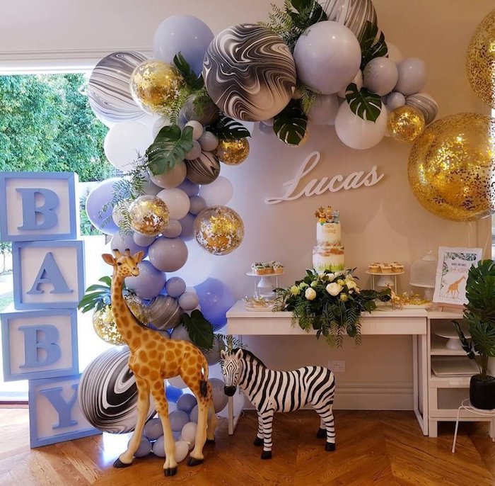 large baby cubes, big balloon arch, giraffe and zebra toys, baby shower decoration ideas for boy, flowers and greenery