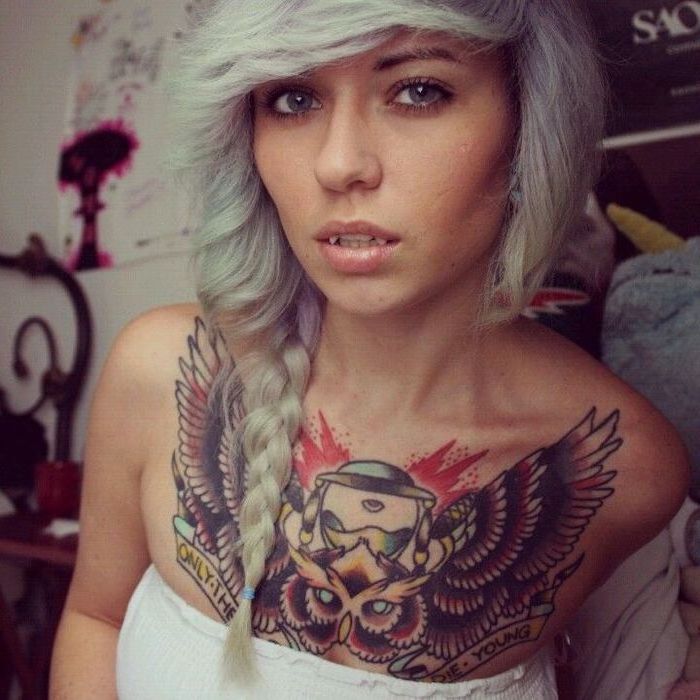 blonde and blue braided hair, large wings and owl colourful tattoo, tattoo between breast, white top