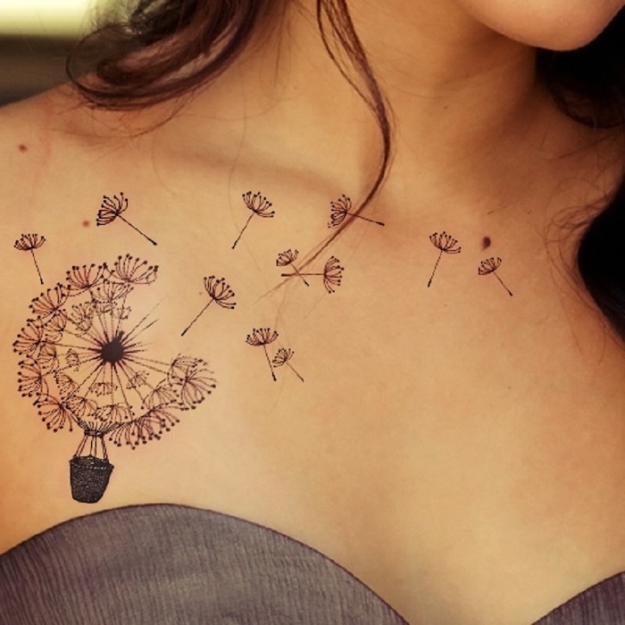 hot air balloon carried by a dandelion, floating dandelion seeds, tattoos for woman, grey top