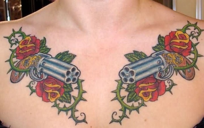 two guns, red roses and green thorns on both shoulders, small chest tattoos