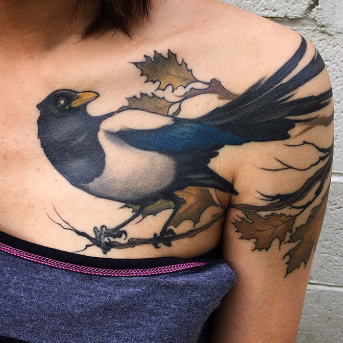 small chest tattoos, large bird on a tree branch on the shoulder, grey top and background