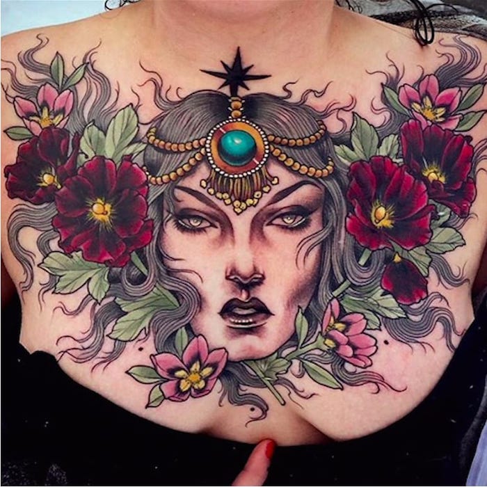 black top, large pink flowers and green leaves, large female face, tattoos for women with meaning
