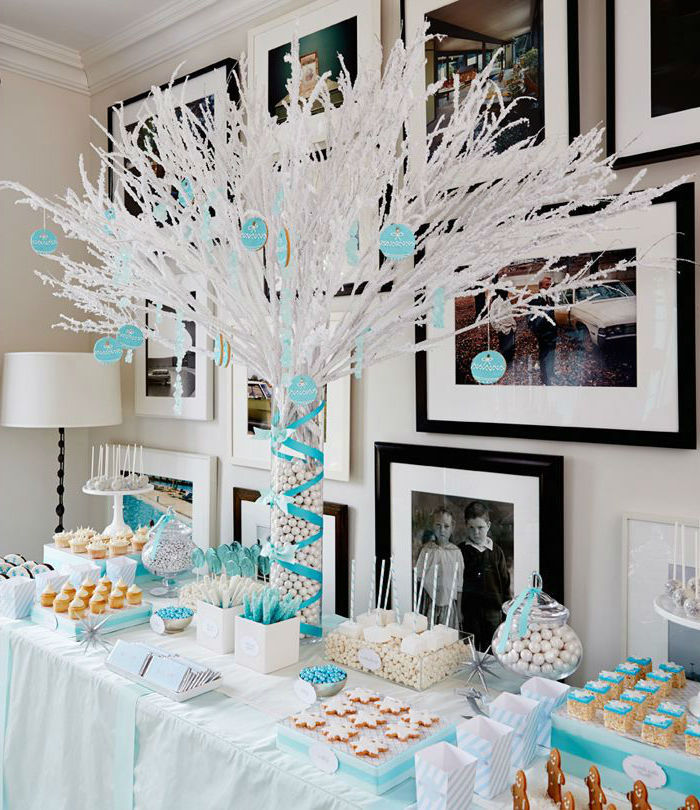 plastic white tree, sweets on the table, photo frames on the wall, blue ribbons, unique boy baby shower themes