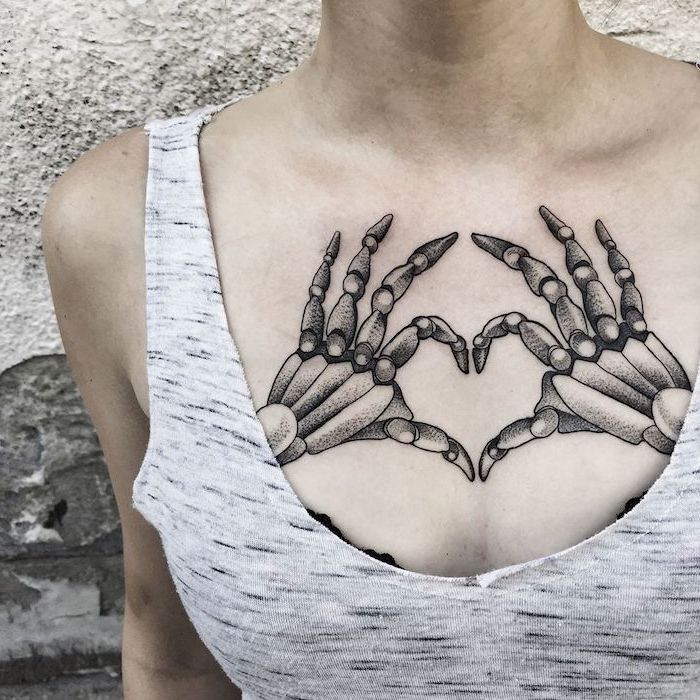 grey top and background, skeleton hands, heart shaped tattoo, tattoos for women