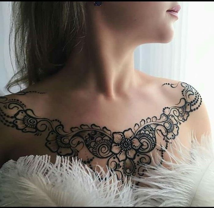 white feathers, symmetrical flowers tattoo on shoulders, brown hair, unique tattoos for women