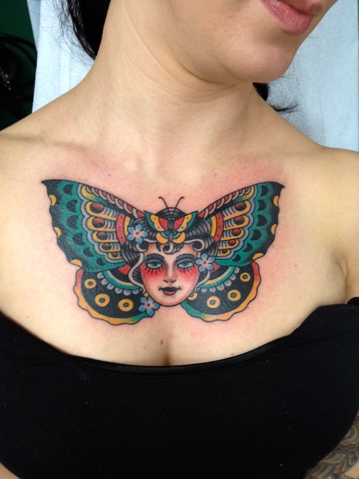 black top, blue yellow and red butterfly, chest tattoo designs, female face in the middle