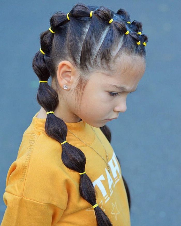 balloon ponytails, yellow rubber bands, braid hairstyles for kids, yellow blouse, blue background