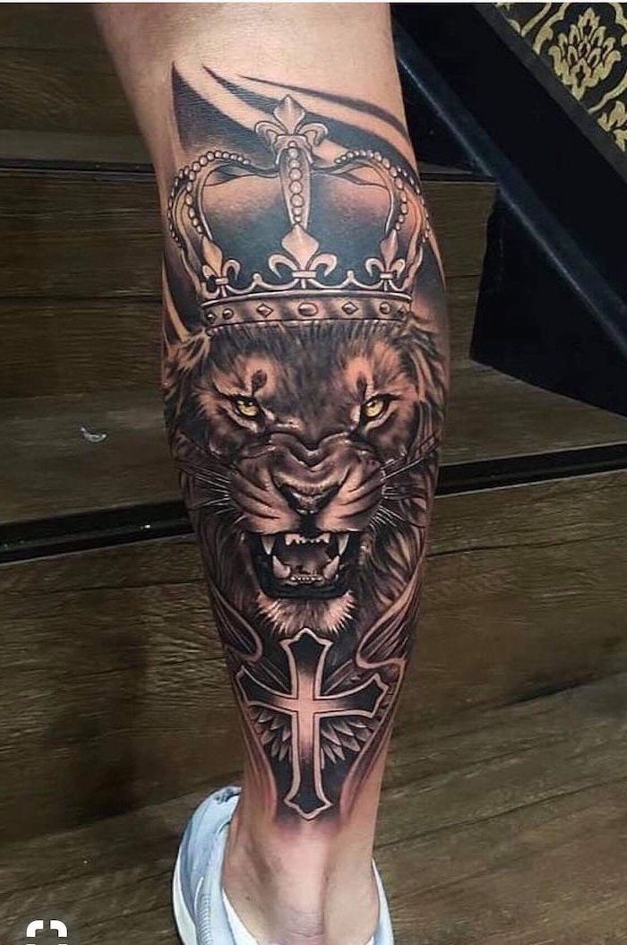 large roaring lion, wearing a crown, leg tattoo, arm tattoos for man, wooden steps, man wearing blue sneakers