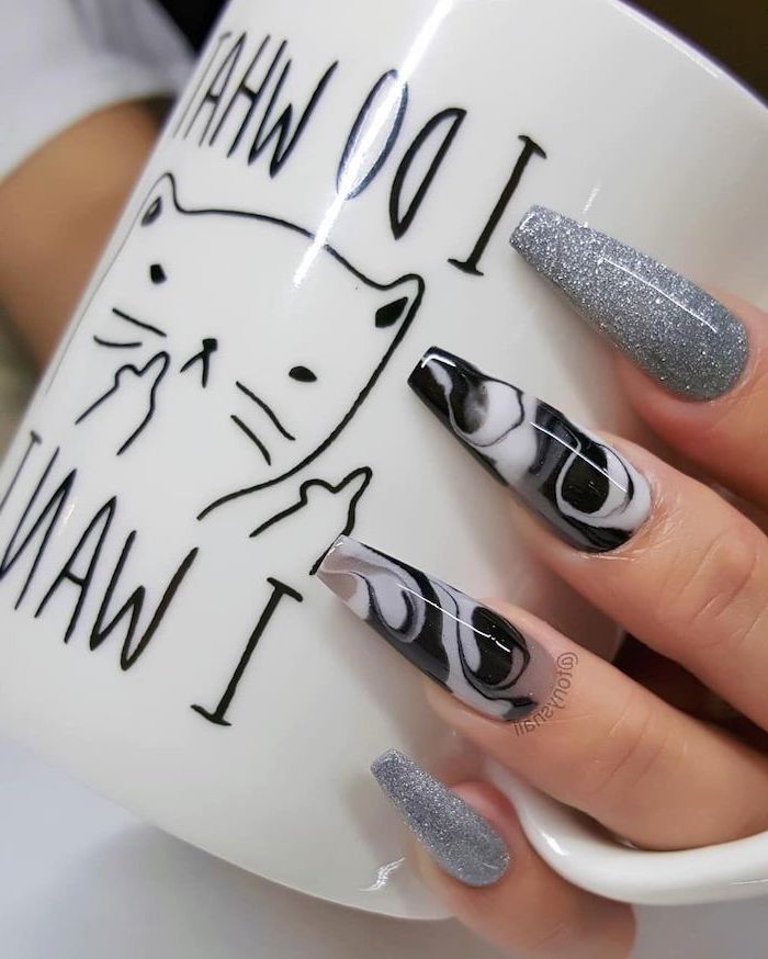 hand holding a mug, cute coffin nails, marble like nails, silver glitter nail polish, long coffin nails
