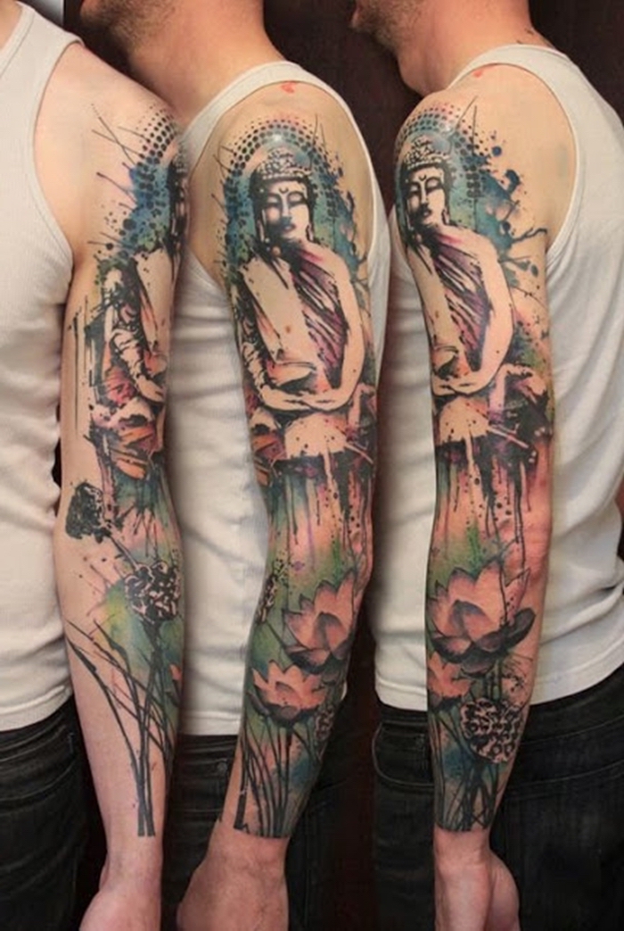buddha and a lotus flower, watercolour arm sleeve tattoo, small tattoos for men, man wearing a white top and jeans