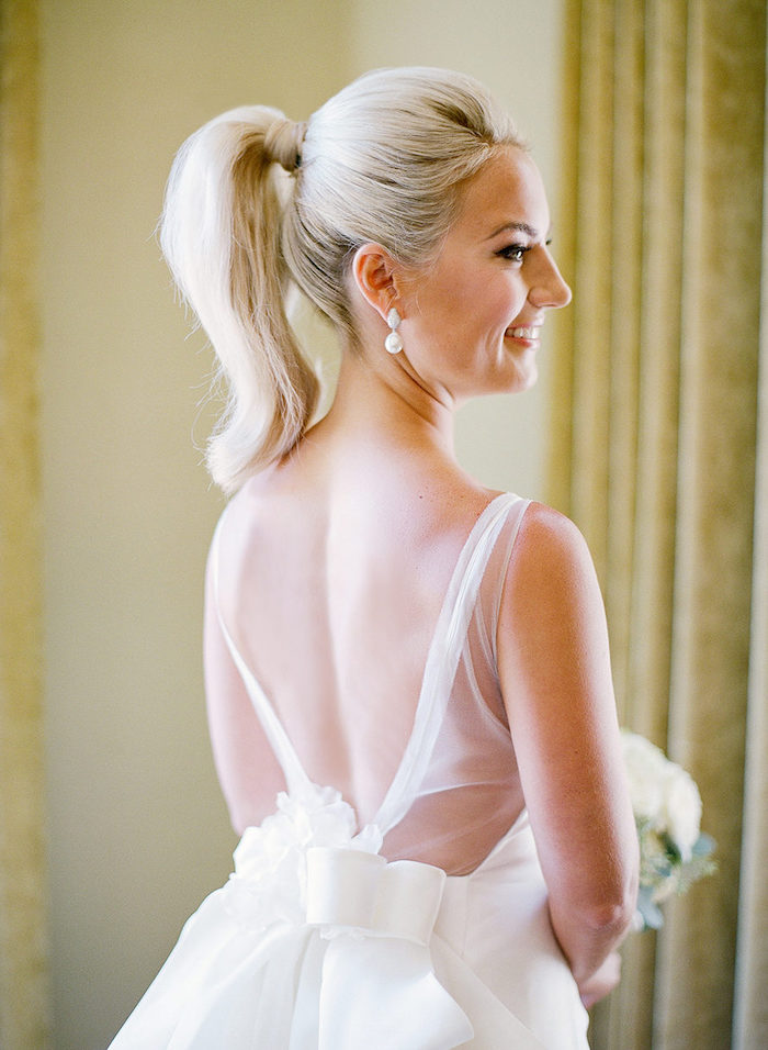white lace dress, with a large bow, blonde hair, in a high ponytail, easy to do hairstyles