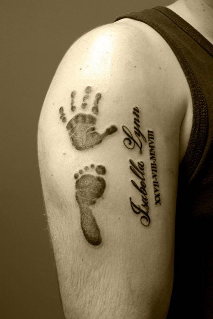 handprint and footprint, shoulder tattoo, roman numeral wrist tattoo, black top