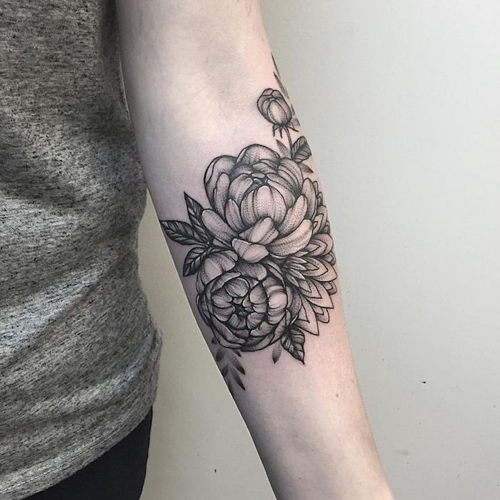 white background, small meaningful tattoos, flower forearm tattoo, grey top