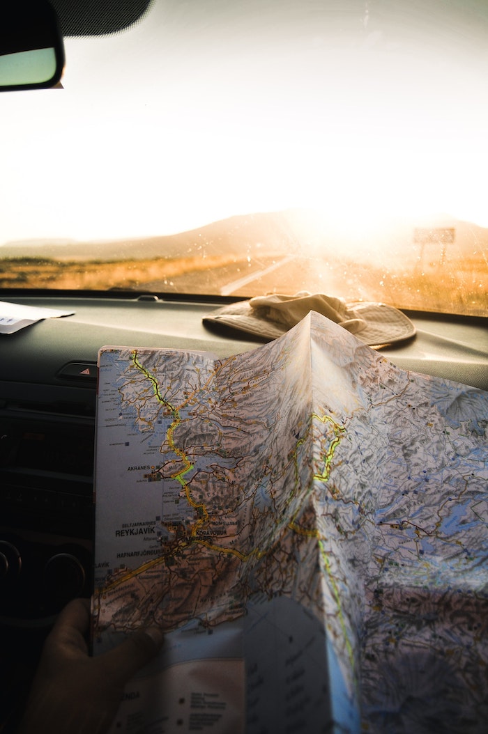 unfolded map, sun setting, down a road, tumblr wallpaper, hat in a car