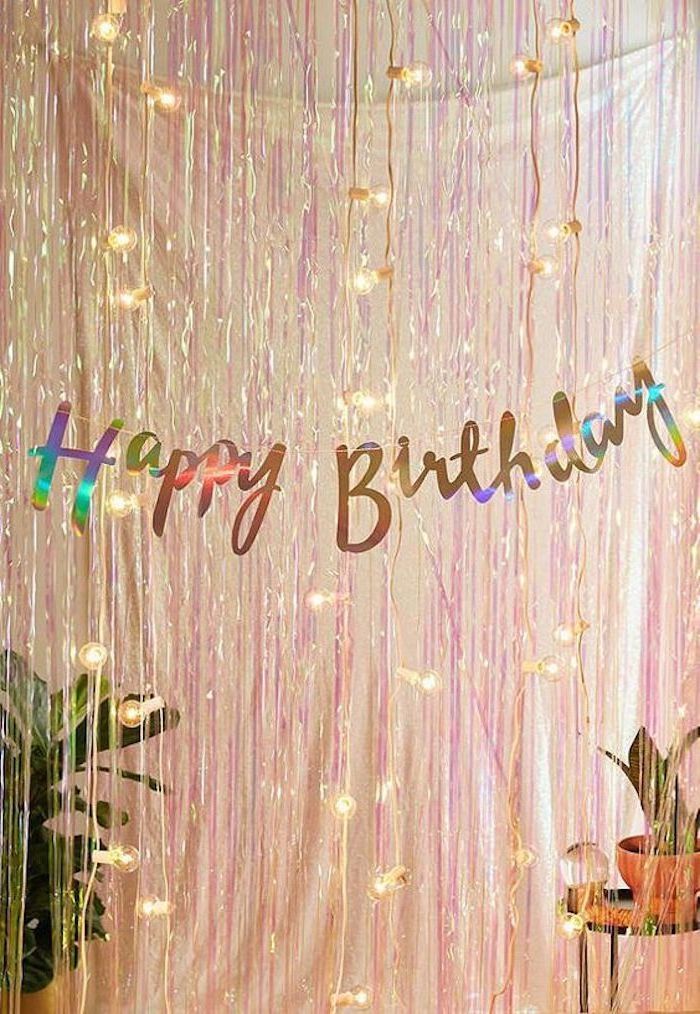 happy birthday sign, pink tassel garland, fairy lights, fun birthday ideas, potted plants