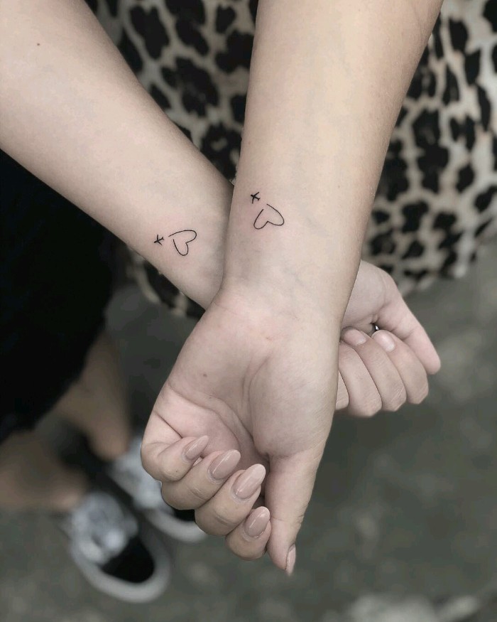 friendship tattoos, hearts and airplanes, wrist tattoos, black and white photo