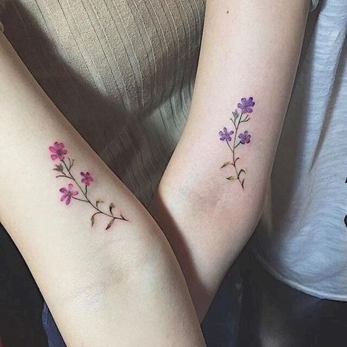 pink and blue flowers, inside arm tattoos, small friendship tattoos, grey and blue blouses