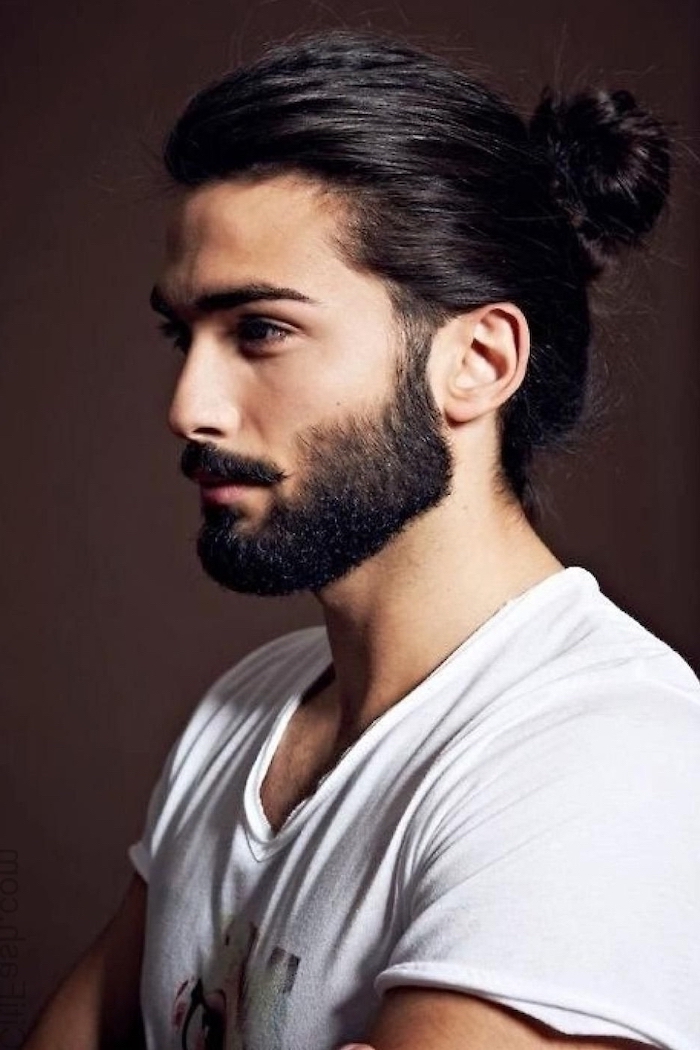 black hair and beard, man bun, cool haircuts for men, white shirt, dark background
