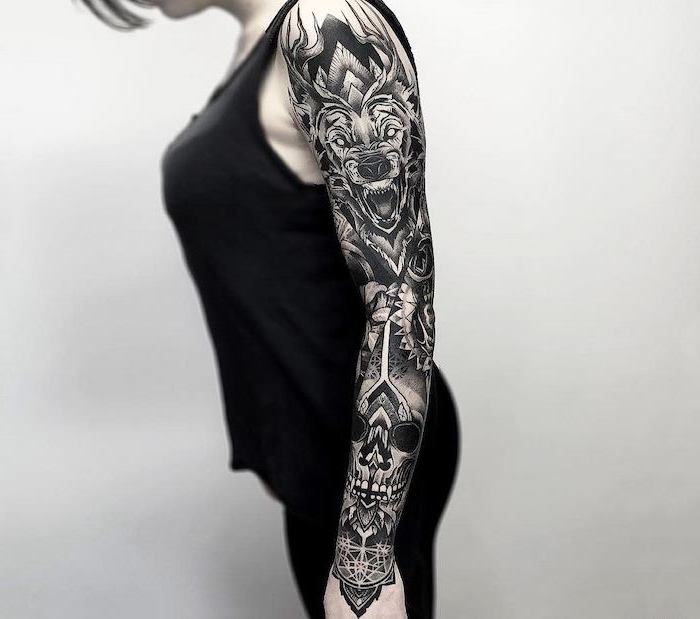 black top, black pants, white background, lion and skull, arm tattoos for women