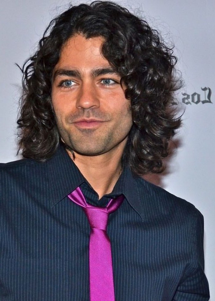 black curly hair, black shirt, pink tie, medium length hair men, adrian grenier, blue eyes