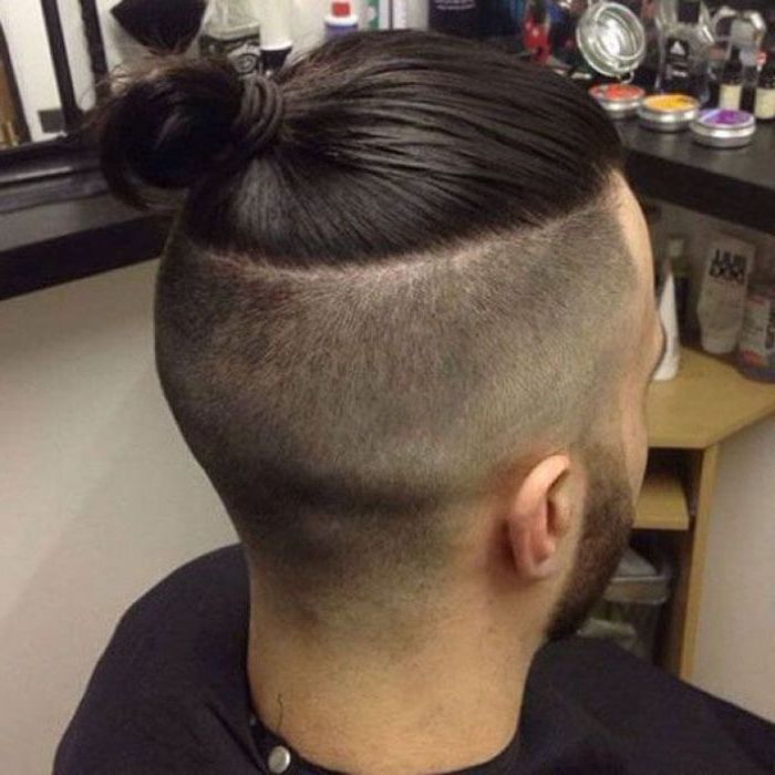 black hair undercut, shaved sides, long top, in a bun, hairstyles for men with thick hair