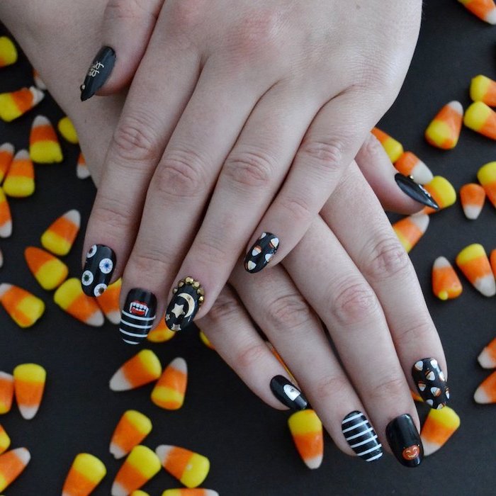 candy corn, black nail polish, nail ideas, different decorations, on each finger, squoval nails