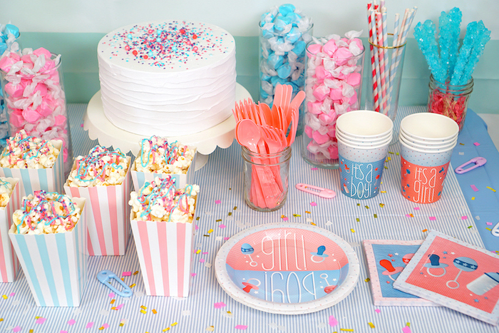 sweet popcorn, pink and blue candy, gender reveal party ideas, white cake frosting, sprinkles on top
