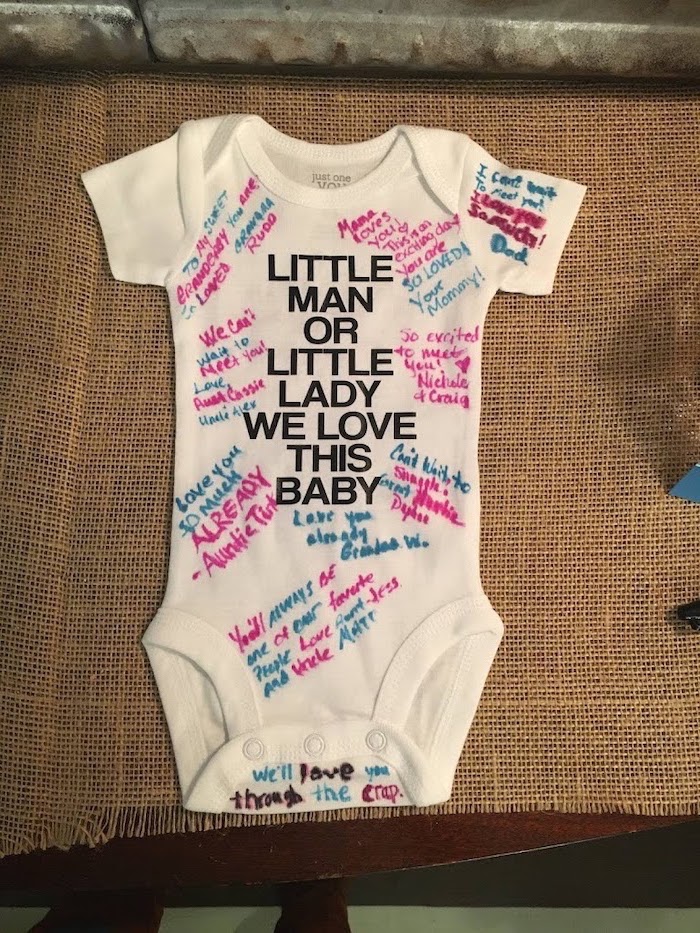 white onesie, little man, or little lady, we love this baby, gender reveal ideas for family, signed with pink and blue markers