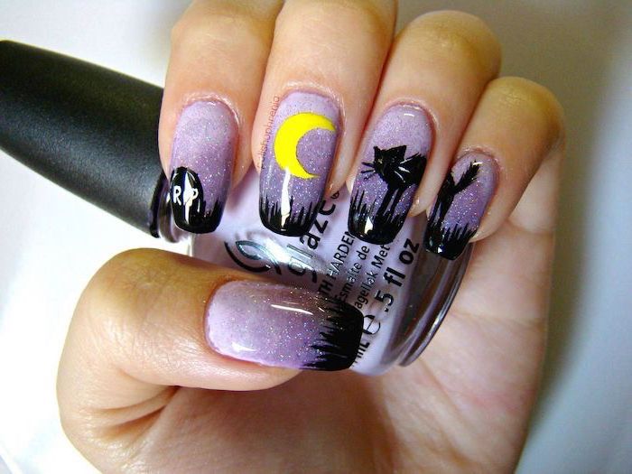 purple glitter nail polish, cute halloween nails, black cat decorations, holding purple nail polish bottle