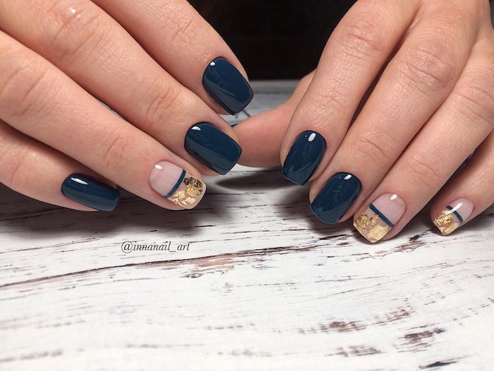 dark blue nail polish, gold glitter, nail decorations, nail color ideas, wooden table, short squoval nails