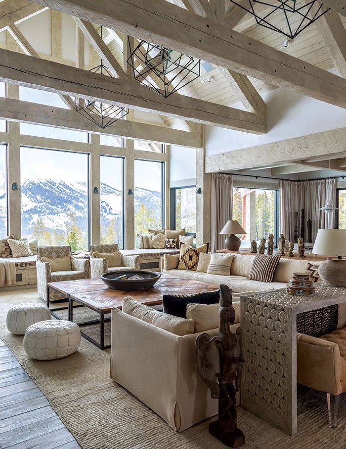 tall windows, mountain landscape, what is a vaulted ceiling, wooden floor, white sofas, wooden table