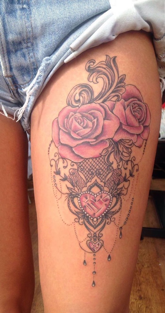 denim shorts, rose thigh tattoo, two pink roses, pink heart shaped crystals, wooden floor