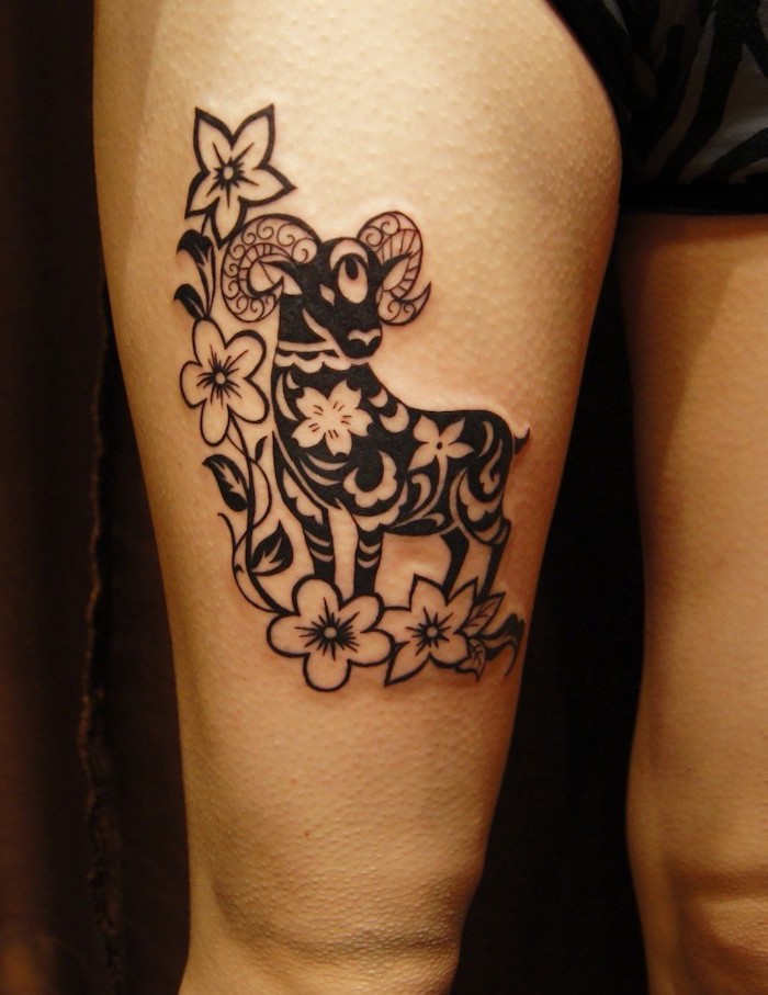rose thigh tattoo, black ram, floral design, black shorts, black background