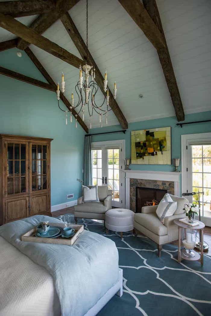 hanging chandelier, blue carpet, turquoise walls, vaulted ceiling kitchen, wooden cupboard, rustic decor