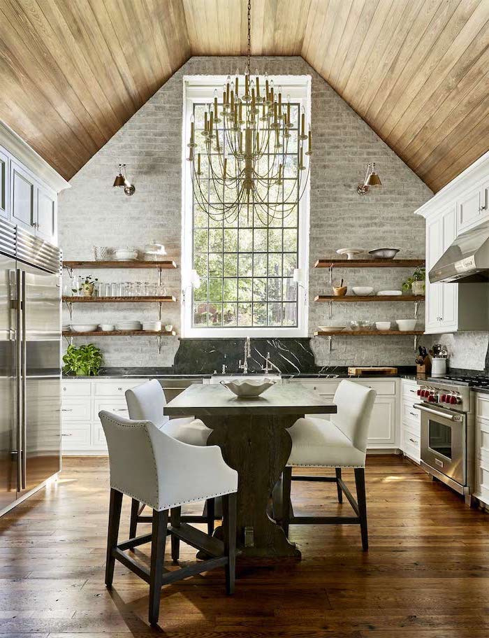 brick wall, open shelving, what does vaulted mean, hanging chandelier, wooden floor, wooden table
