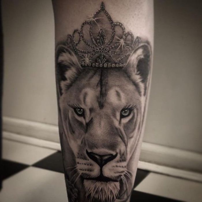 back of leg tattoo, lioness head with sparkling crown on top, lioness tattoo, black and white photo