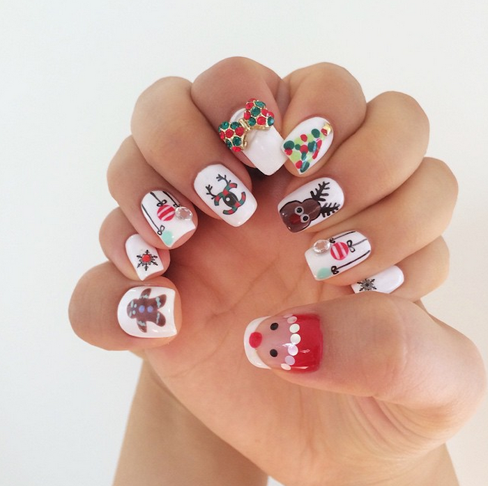 short squoval nails with white nail polish, different christmas theme decorations on each nail, winter nail colors