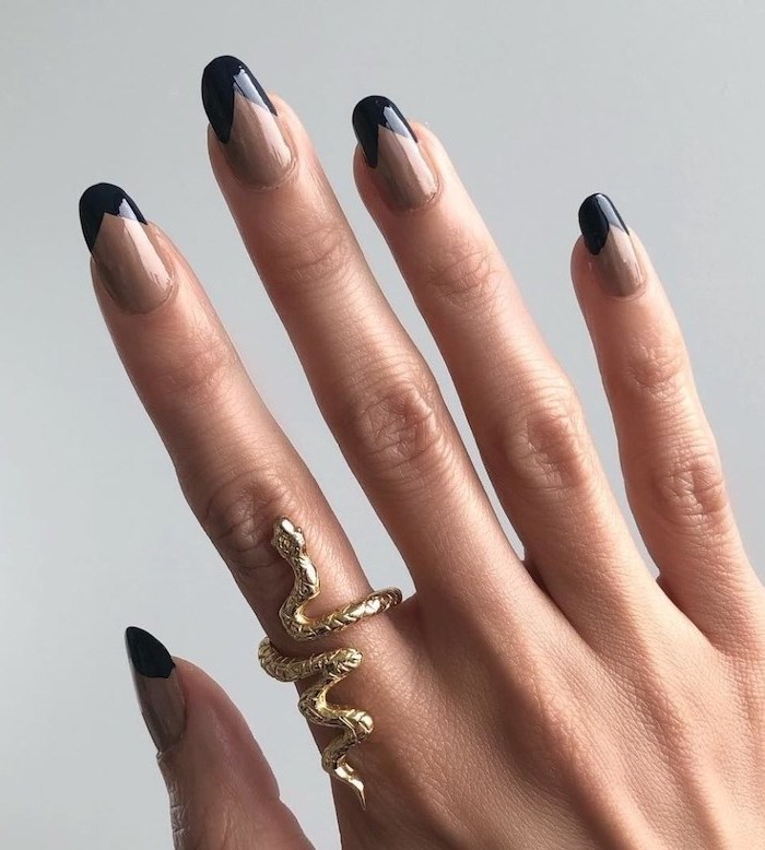 long nails with beige nail polish, black french manicure, winter nail colors, female hand with gold snake ring on the index finger
