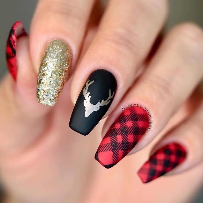 red and black matte nail polish, white and gold nails, plaid decorations, gold glitter and stag on index and middle finger