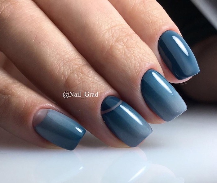 winter nails, gradient shades of blue nail polish, short squoval nails, hand placed on white surface