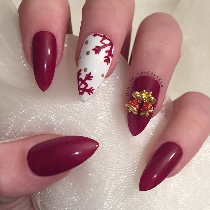 red and white nail polish, nude nail designs, snowflakes decoration on middle finger, gold rhinestone bells on ring finger